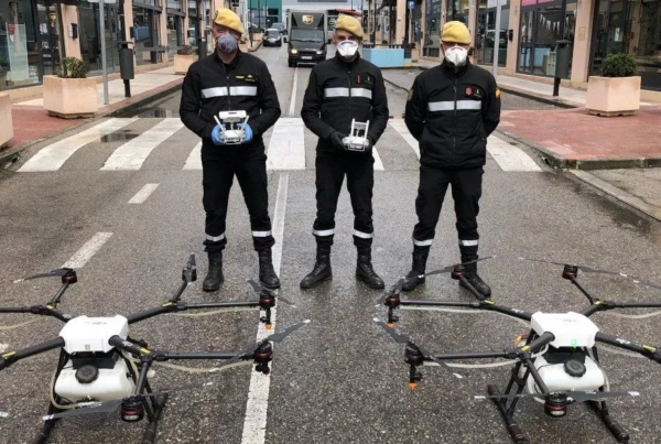 Sanitization workers with DJI Agras MG 1S drones for spraying