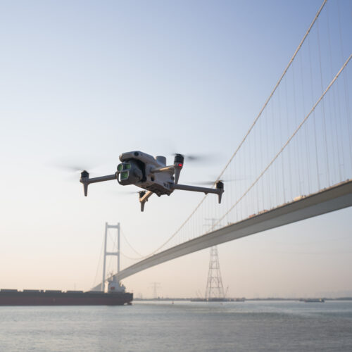 dji matrice 4 flying over a bridge